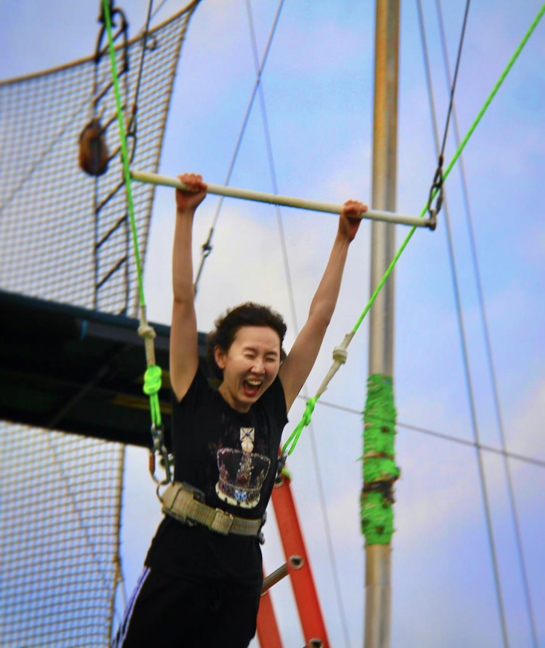 Woman trying out a trapeze bar